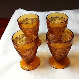 Set of four Tiara Exclusives amber Sandwich pattern 6 oz. juice glasses.